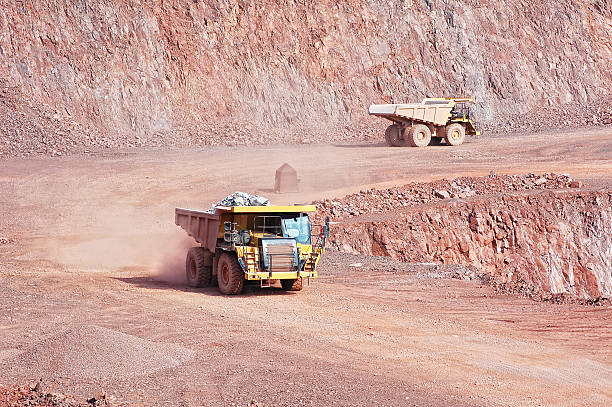 two dumper trucks in surface mine quarry. mining industry. two dumper trucks in surface mine quarry. mining industry.